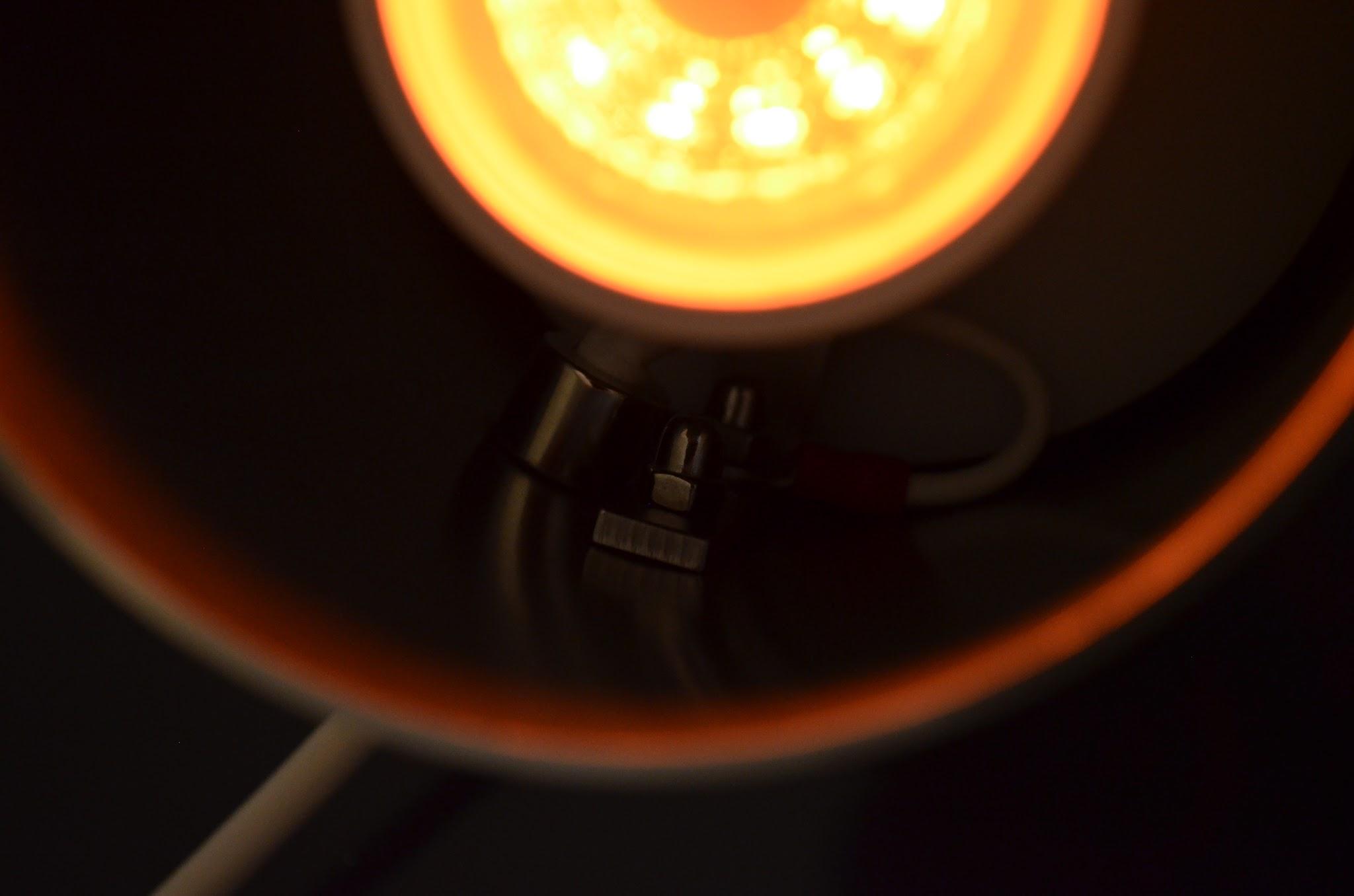 Dark studio backdrop behind the 90`s Pisa luminaire