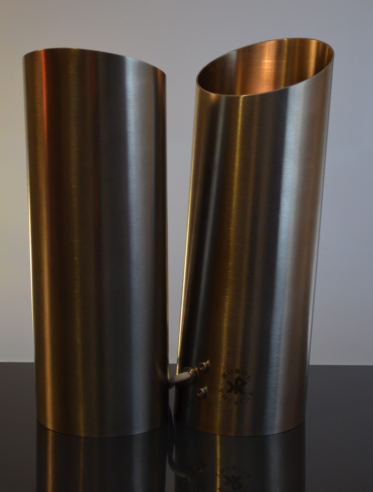 Two brushed stainless steel luminaires side by side
